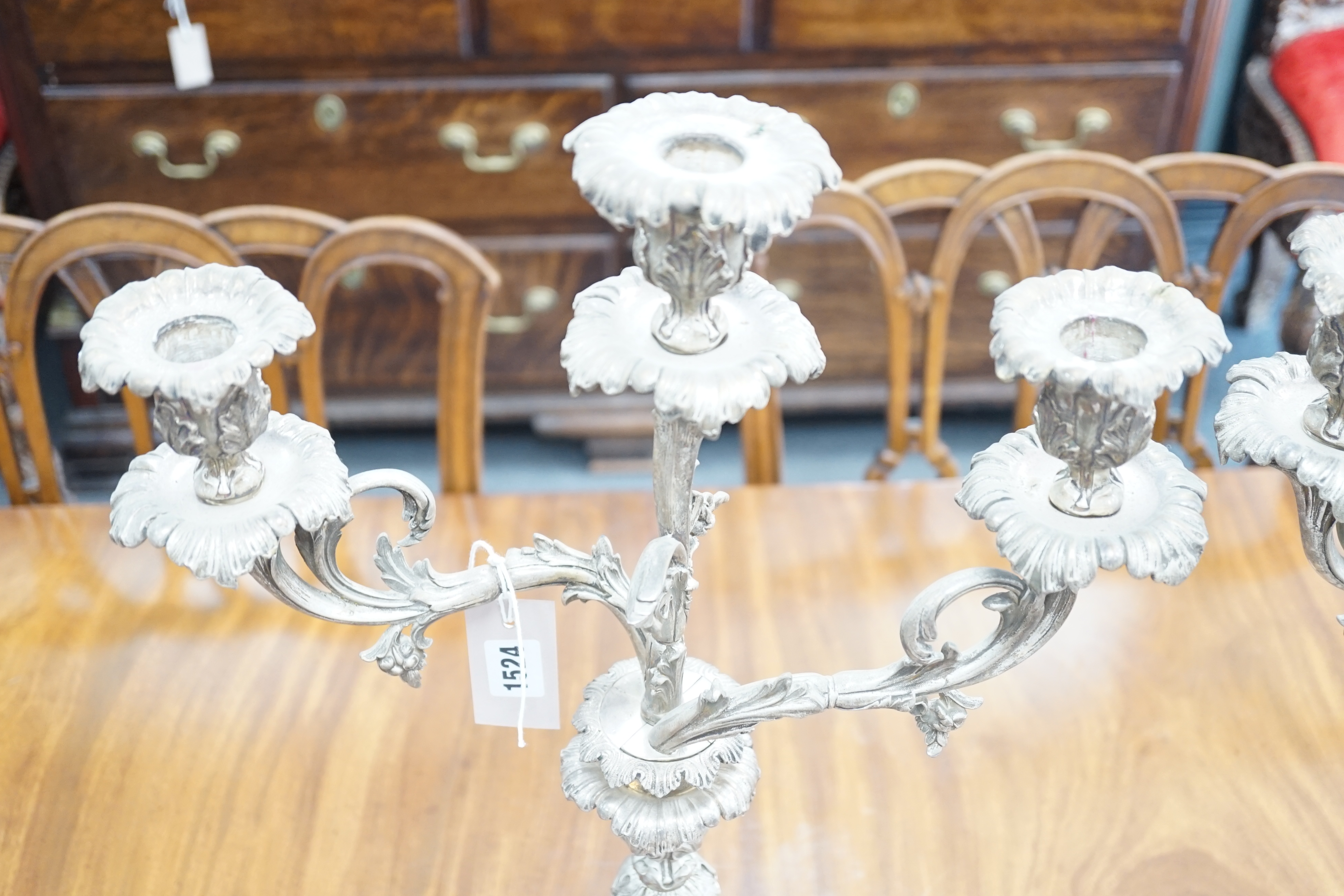 A large pair of plated two branch, three light candelabra, 58cm high, 37cm wide